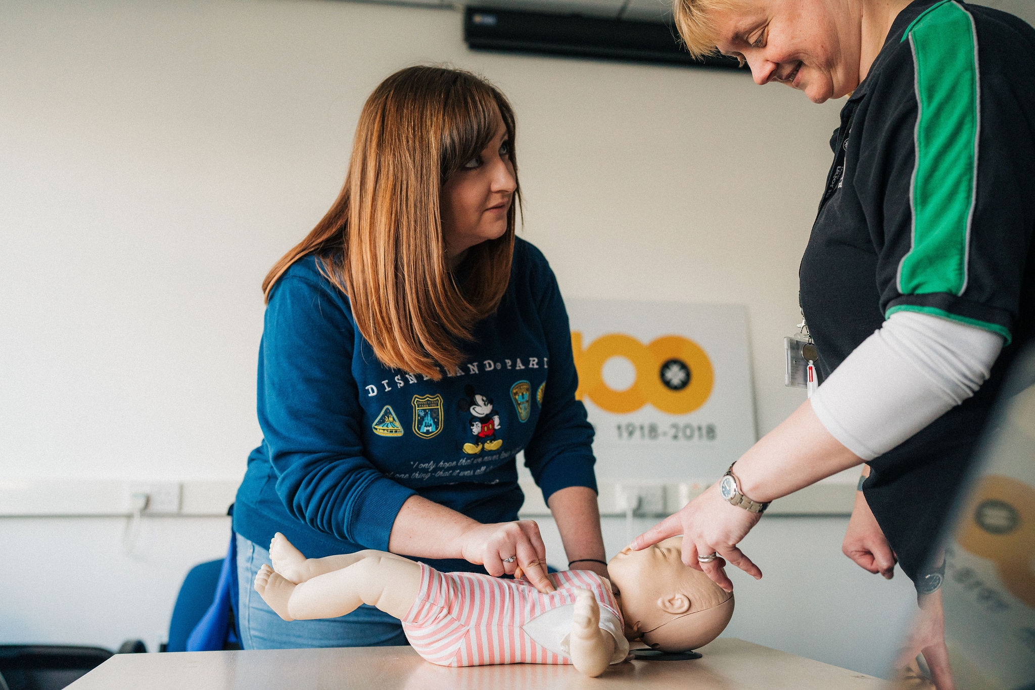 a woman performing baby cpr
